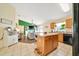 Open concept kitchen overlooking living area, showcasing kitchen island and modern appliances at 7327 Sw 129Th Ln, Ocala, FL 34473