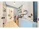 Well-lit laundry room with side by side washer and dryer and added storage solutions at 7327 Sw 129Th Ln, Ocala, FL 34473
