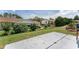 A patio extends into a grassy yard with beautiful landscaping in this home's backyard at 8128 Sw 117Th Loop Loop, Ocala, FL 34481
