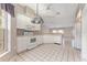 Open kitchen area showcasing white appliances and cabinetry, seamlessly connecting to the rest of the home at 8128 Sw 117Th Loop Loop, Ocala, FL 34481
