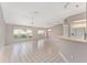 Large, bright living room with white tile, updated ceiling fan, and view to the backyard at 8128 Sw 117Th Loop Loop, Ocala, FL 34481