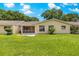 A fenced-in backyard featuring a lush green lawn, a screen porch, and mature trees at 8351 Sw 93Rd Ln # C, Ocala, FL 34481