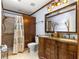Bathroom with a decorative tiled shower and large vanity with double sinks at 8351 Sw 93Rd Ln # C, Ocala, FL 34481