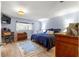 Comfortable bedroom with wood floors, dresser, and ample natural light from the exterior windows at 8351 Sw 93Rd Ln # C, Ocala, FL 34481