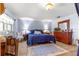 Comfortable bedroom with wood floors, dresser, and ample natural light from the exterior windows at 8351 Sw 93Rd Ln # C, Ocala, FL 34481
