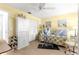 Bedroom featuring bright yellow walls, laminate wood floors, and plenty of storage at 8351 Sw 93Rd Ln # C, Ocala, FL 34481
