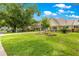 Charming home featuring a well-manicured front lawn, mature trees, and a covered porch at 8351 Sw 93Rd Ln # C, Ocala, FL 34481