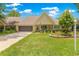 Inviting one-story home featuring a well-maintained lawn, charming front porch, and attached garage at 8351 Sw 93Rd Ln # C, Ocala, FL 34481