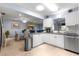 Bright kitchen with granite countertops, stainless steel appliances, and an open design that flows to the dining area at 8351 Sw 93Rd Ln # C, Ocala, FL 34481