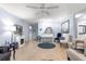 Open-concept living room with hardwood floors, neutral paint, and an elegant white piano at 8351 Sw 93Rd Ln # C, Ocala, FL 34481