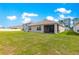 Home exterior overlooking a sprawling backyard with a screened-in porch at 8685 Sw 49Th Cir, Ocala, FL 34476