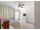 Cozy bedroom with a ceiling fan, window, and decorative ivy at 8685 Sw 49Th Cir, Ocala, FL 34476