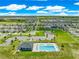 Aerial image showing a pristine community pool and clubhouse surrounded by green lawns in a well-planned neighborhood at 8685 Sw 49Th Cir, Ocala, FL 34476