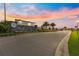 Greystone Hills community sign and entrance with palm trees set against a beautiful sunset sky at 8685 Sw 49Th Cir, Ocala, FL 34476