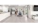 A bright, open dining area showcasing modern decor, and neutral colors with white cabinets and stainless appliances at 8685 Sw 49Th Cir, Ocala, FL 34476