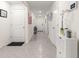 Bright hallway featuring light gray tile flooring and an open layout, with white walls and doors at 8685 Sw 49Th Cir, Ocala, FL 34476