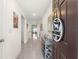 Bright and inviting home hallway with gray tile flooring and stylish decor at 8685 Sw 49Th Cir, Ocala, FL 34476