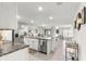 Open-concept kitchen with an island, stainless steel appliances, and seamless flow to the living areas at 8685 Sw 49Th Cir, Ocala, FL 34476