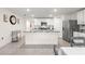 Bright kitchen featuring an island, white cabinets, stainless steel appliances, and stylish backsplash at 8685 Sw 49Th Cir, Ocala, FL 34476