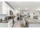 Modern kitchen featuring stainless steel appliances, granite countertops, and white cabinetry at 8685 Sw 49Th Cir, Ocala, FL 34476