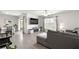 Open-concept living space with modern décor, a comfortable couch, and natural light coming from a large window at 8685 Sw 49Th Cir, Ocala, FL 34476