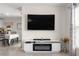 Living room featuring a large TV, fireplace, and an adjacent dining area at 8685 Sw 49Th Cir, Ocala, FL 34476