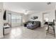 Bright living area featuring comfortable seating, a ceiling fan, and natural light streaming through the window at 8685 Sw 49Th Cir, Ocala, FL 34476
