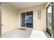 Covered patio with a sliding glass door entrance and a welcome mat, perfect for outdoor relaxation at 8685 Sw 49Th Cir, Ocala, FL 34476