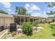 Spacious backyard with well-kept lawn, landscaping, and a screened-in patio area at 9085 Sw 96Th Ln # B, Ocala, FL 34481