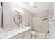 Bright bathroom features a shower over tub, modern vanity, and stylish round mirror at 9085 Sw 96Th Ln # B, Ocala, FL 34481