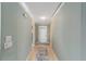 Hallway with neutral paint and tile floors leading to a front door at 9085 Sw 96Th Ln # B, Ocala, FL 34481