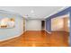 View of the living room, featuring neutral walls, wood floors, and an open space at 9085 Sw 96Th Ln # B, Ocala, FL 34481