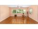 Light-filled living room with wood floors, ceiling fan, and multiple windows at 9085 Sw 96Th Ln # B, Ocala, FL 34481