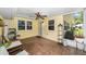 Screened patio with ceiling fan and tile flooring, perfect for outdoor relaxation at 9085 Sw 96Th Ln # B, Ocala, FL 34481