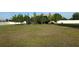 A view of backyard, featuring a white fence, young trees, and plenty of green space at 9923 Se 64Th Ave, Belleview, FL 34420
