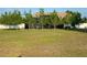 Spacious backyard featuring several trees and a screened-in lanai, perfect for privacy at 9923 Se 64Th Ave, Belleview, FL 34420