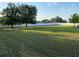 Expansive backyard enclosed by a white fence, offering privacy and space at 9923 Se 64Th Ave, Belleview, FL 34420