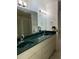 Bathroom offers a double sink vanity with mirror and decorative lighting at 9923 Se 64Th Ave, Belleview, FL 34420