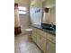Bathroom features tile flooring, vanity, shower/tub, and a window for natural lighting at 9923 Se 64Th Ave, Belleview, FL 34420