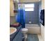 Cozy bathroom featuring blue tile, shower-tub combo, and fun under-the-sea themed decor at 9923 Se 64Th Ave, Belleview, FL 34420