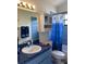 Bathroom with blue tile, vanity and under-the-sea decor accents at 9923 Se 64Th Ave, Belleview, FL 34420