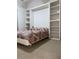 Bedroom showcases built-in shelving and a Murphy bed for flexible use of space at 9923 Se 64Th Ave, Belleview, FL 34420