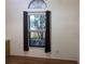 Bedroom featuring a window with blinds and curtains, and wood flooring at 9923 Se 64Th Ave, Belleview, FL 34420