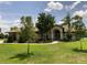 Beautiful home with a well-manicured lawn and inviting entryway with classic architectural columns at 9923 Se 64Th Ave, Belleview, FL 34420