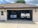 Two-car garage with plenty of room and vehicles parked inside at 9923 Se 64Th Ave, Belleview, FL 34420