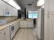 Bright kitchen with white appliances and a view to living spaces beyond a breakfast bar at 9923 Se 64Th Ave, Belleview, FL 34420