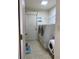Well-equipped laundry room with modern washer and dryer, as well as a storage shelf at 9923 Se 64Th Ave, Belleview, FL 34420
