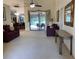 Spacious living room with plush seating and a view of the outdoor patio and pool area at 9923 Se 64Th Ave, Belleview, FL 34420