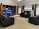 Comfortable living room featuring plush black reclining seating and an entertainment center at 9923 Se 64Th Ave, Belleview, FL 34420