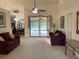 Spacious living room with plush seating and a view of the outdoor patio and pool area at 9923 Se 64Th Ave, Belleview, FL 34420
